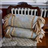 D79. Pair of fringed bolster pillows.  